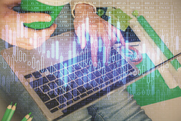 Double exposure of woman hands typing on computer and forex chart hologram drawing. Stock market invest concept.