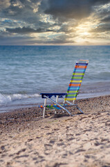 Fototapeta na wymiar Folding chair on the beach, a great place to relax and watch the sun set