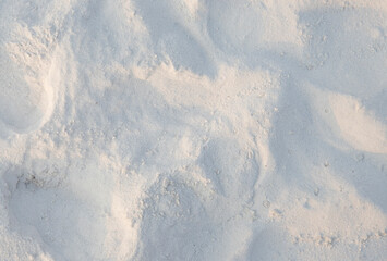 White sand on the beach, abstract summer background. Sandy seashore top view photo. Tropical beach banner
