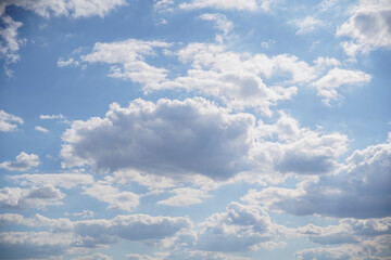 Fototapeta premium Blue sky on a sunny day with fluffy white clouds. Nature background.