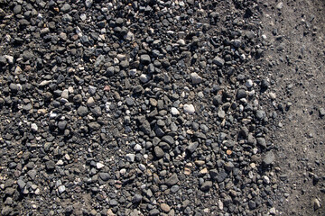 Grey gravel texture. Rustic road surface top view photo. Off-road ride or drive concept. Black...