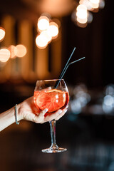 Aperol spritz in the hands of a girl. Aperol spritz. Cocktail.