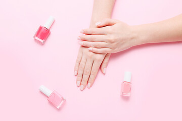 Woman's hands with beautiful manicure on pink background. Hands spa concept