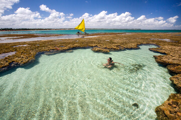 Woman swimming and relaxing on natural pool in Porto de Galinhas, Pernambuco - Brazil. Brazilian...