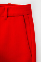 side pocket of trousers made of red fabric with a part of the belt with loops