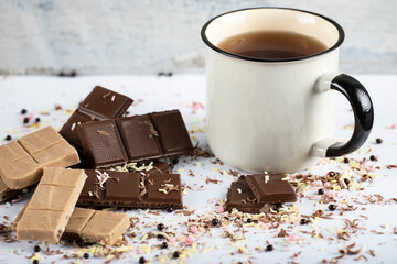 Milky and dark chocolate pieces with a cup of tea