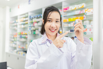 asian female pharmacist explain about how to use inhaler medicine, asthma clinic, she holding...
