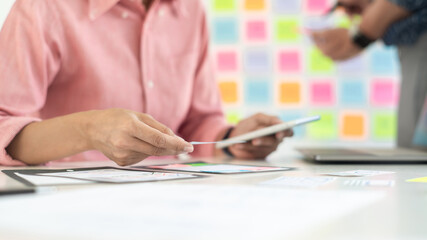 Business team working with plan on office desk with new startup project analysing financial document data

