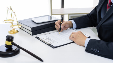 lawyer working on desktop  with legal case document in workplace for consultant