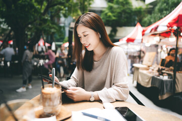 Young adult business asian woman use tablet for business at outdoor cafe