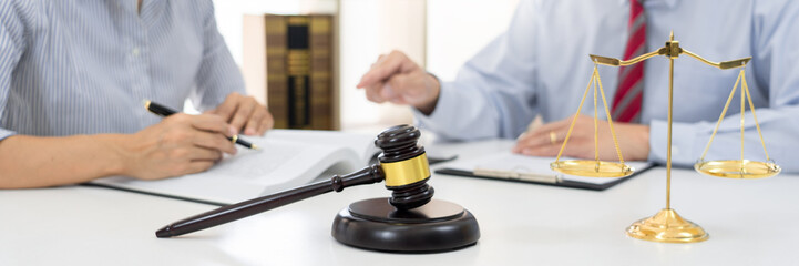 Client with his partner lawyers or attorneys discussing discussing a document or contract agreement