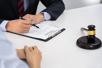Client with his partner lawyers or attorneys discussing discussing a document or contract agreement