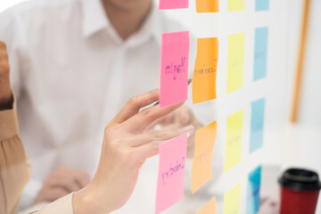 business team planning startup project placing sticky notes session to share idea or brainstorm
