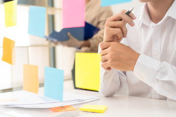 business team planning startup project placing sticky notes session to share idea or brainstorm