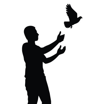 Young man releases a bird to freedom silhouette vector