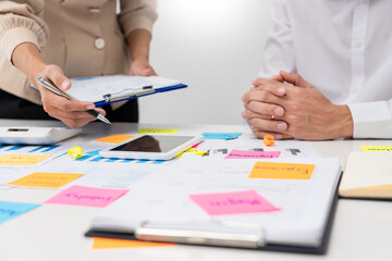 business people planning startup project placing sticky notes session to share idea or brainstorm