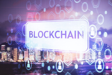 Multi exposure of cryptocurrency theme hologram drawing and city veiw background. Concept of blockchain and bitcoin.