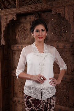 Beautiful woman wearing an elegant kebaya, kebaya is a traditional dress worn by Indonesian and Malaysian women made from gauze cloth worn with batik.