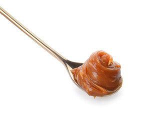 Spoon with liquid caramel on white background