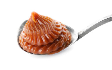 Spoon with liquid caramel on white background