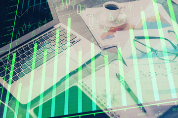 Stock market graph and table with computer background. Multi exposure. Concept of financial analysis.