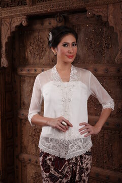 Beautiful woman wearing an elegant kebaya, kebaya is a traditional dress worn by Indonesian and Malaysian women made from gauze cloth worn with batik.