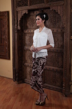 Beautiful woman wearing an elegant kebaya, kebaya is a traditional dress worn by Indonesian and Malaysian women made from gauze cloth worn with batik.