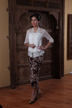 Beautiful woman wearing an elegant kebaya, kebaya is a traditional dress worn by Indonesian and Malaysian women made from gauze cloth worn with batik.
