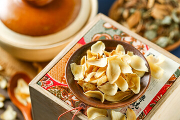 Dried lilies on a plate in front of a casserole background