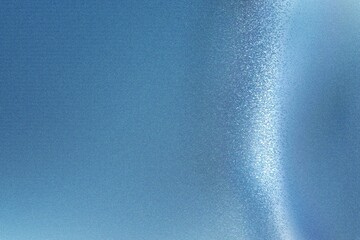 Light shining down on blue foil metallic wall, abstract texture background