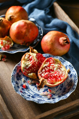 Red pomegranate in a ceramic plate