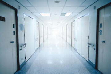 Blurred perspective view of modern hospital or clinic corridor interior.