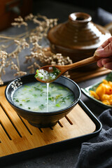 vegetable congee in black bowl