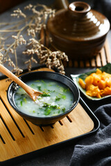 vegetable congee in black bowl