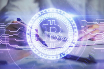 Cryptocurrency hologram over woman's hands writing background. Concept of blockchain. Double...