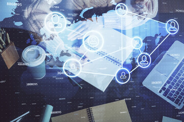 Social network theme hologram over woman's hands writing background. Concept of international people connect. Double exposure