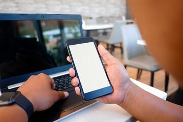 Cropped shot view of man’s Hands hold the smartphone with blank copy space screen for your information content or text message on the gray granite at the modern place.