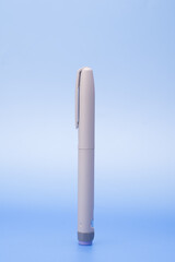 Insulin pen isolated over blue background