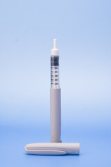 Insulin pen isolated over blue background
