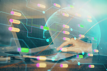 Multi exposure of world map hologram with man working on computer on background. Concept of...