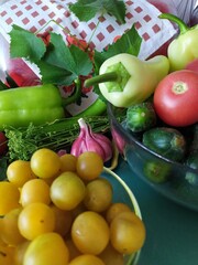 Food still life on the kitchen table pepper tomatoes cucumbers cherry plum garlic dill herbs grape leaves