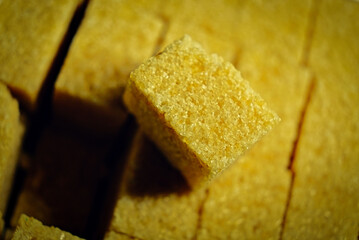 Brown sugar cubes above view, lit from the side