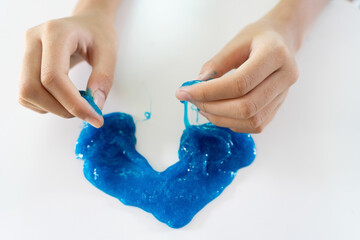Hand Holding Dark Blue Slime, Kids having fun and being creative by science experiment. Selective...