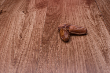 Dry dates over wooden surface