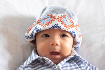 The Portrait of Asian Baby Infant Boy wearing bucket hat