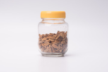 Cardamom inside a see through a jar,over white background