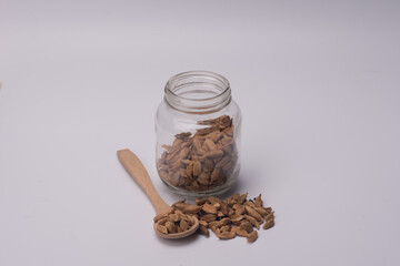 Cardamom inside a see through a jar,over white background