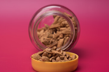 Cardamom herbs over red background