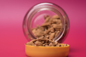 Cardamom herbs over red background