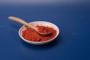 Chili powder over blue background